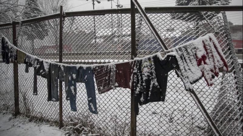 Snow covers clothes left on a line to dry in Srinagar, Kashmir. (Photo: AP)