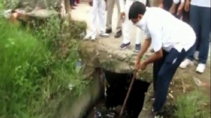 Uttar Pradesh: Rampur DM cleans drains to spread message of equality