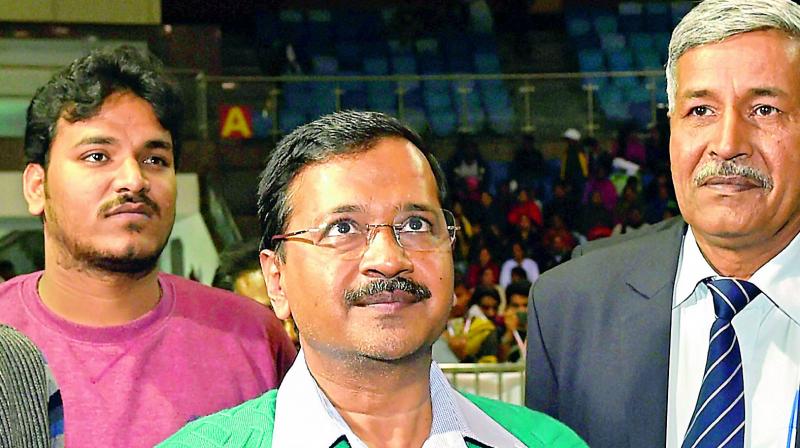 Delhi CM Arvind Kejriwal tosses a coin before a badminton match of the Assembly Sports Tournament on Sunday. (Photo: PTI)