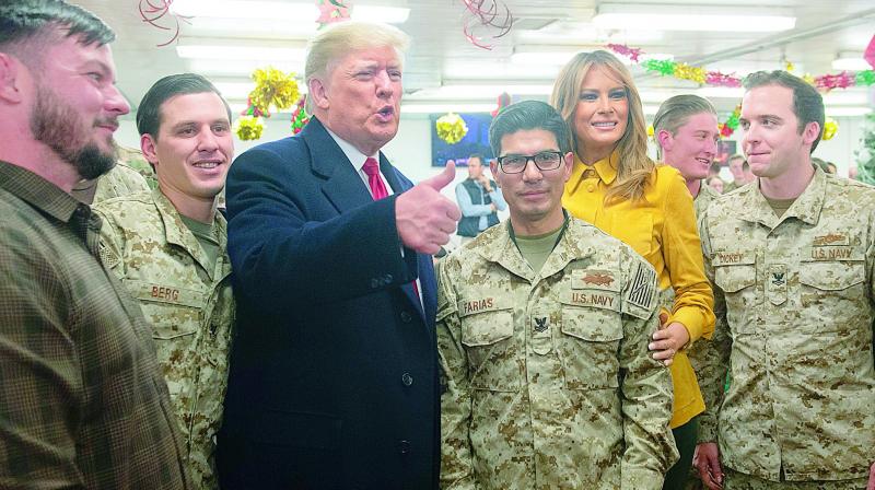 US President Donald Trump greets members of the US military during an  unannounced trip to Al Asad Air Base in Iraq on Wednesday. (AFP)