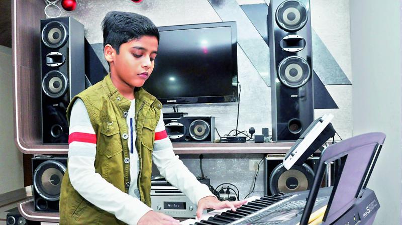 Vivek Varughese Raju plays keyboard at his residence in Visakhapatnam on Monday. (Photo: DC)