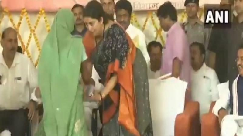 Watch: Woman falls on Smriti Irani\s feet, MP promises to solve her problem in Amethi