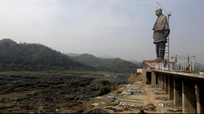 The under construction statue of unity stands facing Sardar Sarovar Dam at Kevadiya Colony, about 200 kilometers from Ahmedabad. (Photo: AP)