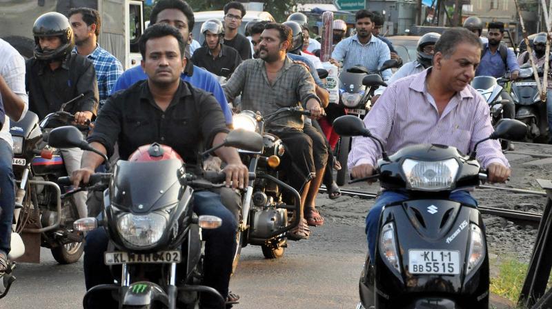 While accident deaths involving two-wheeler riders are on the rise, riders sans helmets are unmindful of the looming threats on road. A scene near YMCA in Kozhikode on Thursday. (Photo: DC)