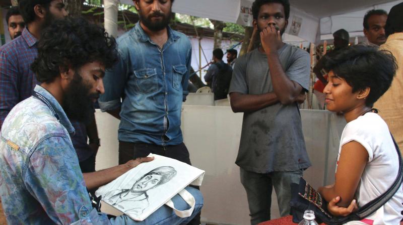 Artist Vigil paints a portrait on Tagore Theatre premises, the main IFFK venue on Monday	 (Photo: G.G. Abhijith)