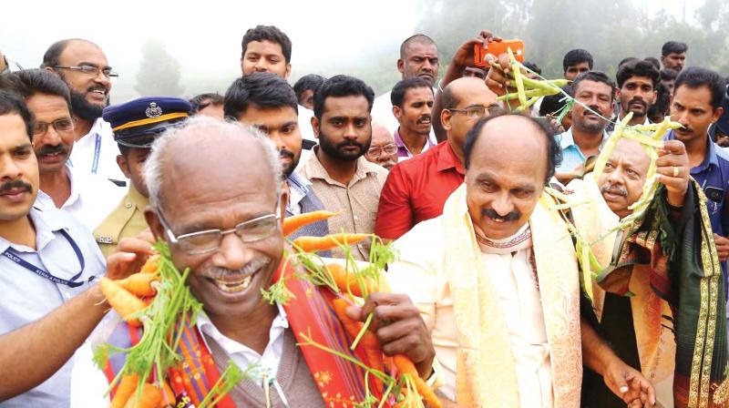 Natives in Neelakurinji Sanctuary area welcome power minister M.M. Mani, revenue minister E. Chandrasekharan and forest minister K. Raju with garlands at the Kadavari community hall on Monday.  (Photo: DC)