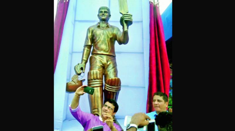 Sourav Ganguly takes a selfie of his own fibre  statue at Balurghat Stadium, in West Bengal on Saturday. (Photo: AP)