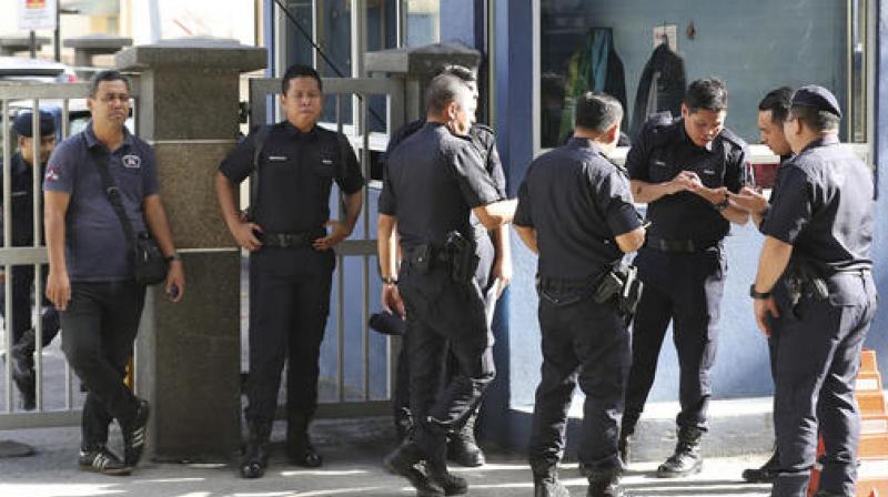 Police officers stand near the entrance of the forensic department at the hospital in Kuala Lumpur. (Photo: AP)