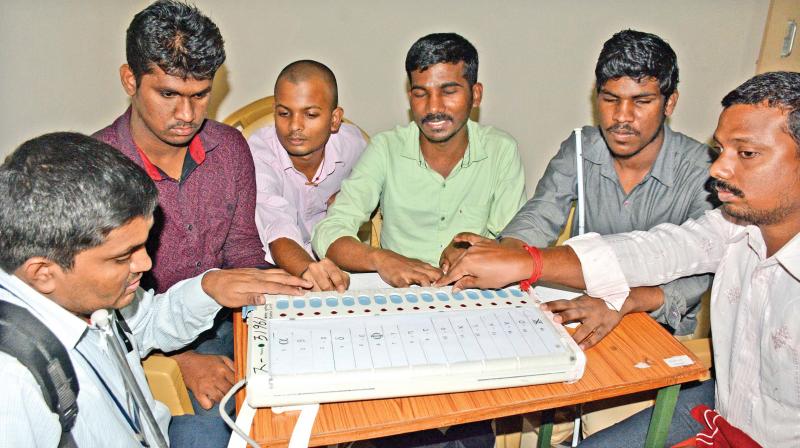People with visual impairment at the Braile verification booth in RK Nagar on Friday. (Photo: DC)