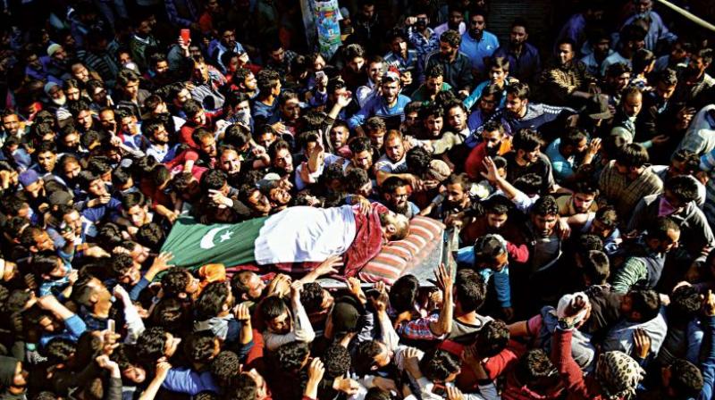 The dead tell a tragic tale: People carrying the body of one of the slain militants wrapped in a Pakistan flag in Shopian on April 1. (Photo: H.U. Naqash)