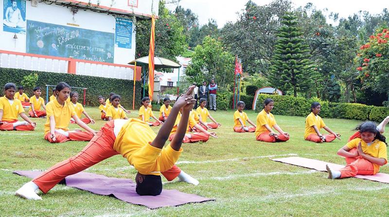 Students at Gurukulam school, near Ooty, showcasing  their yoga skills during the annual sports day. (Photo: DC)