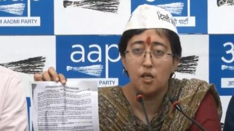 Who sneaked in pamphlets in newspapers maligning AAP\s Atishi Marlena?