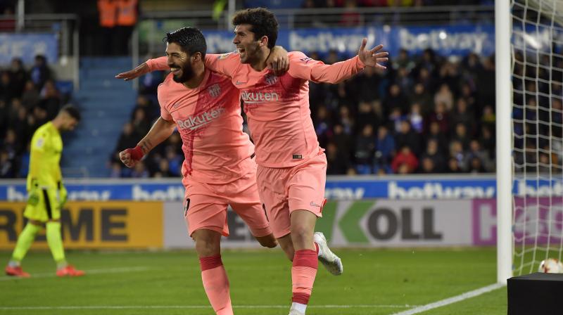 Barcelona edges closer to the La Liga title after a 2-0 win over Alaves