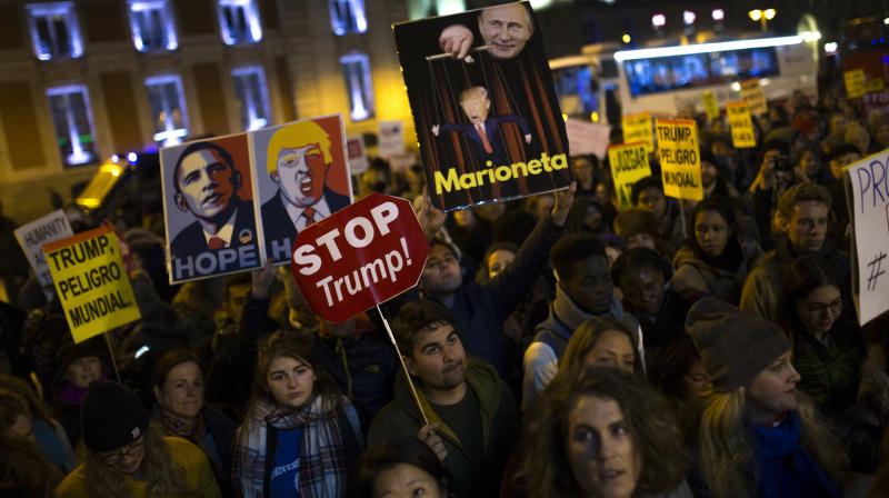 People hold placards as they gather during an anti-Trump rally in Madrid, Friday, Jan. 20, 2017. Donald Trump took the oath of office as the 45th President of the United States. (Photo: AP)