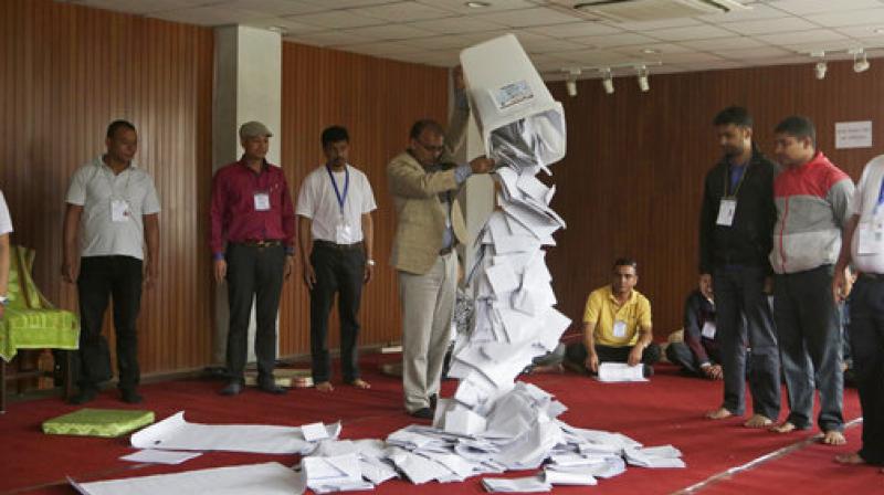 A Nepalese election commission officer empties a ballot box prior to counting the votes of local elections in Kathmandu, Nepal on 15 May 2017. (Photo: AP)