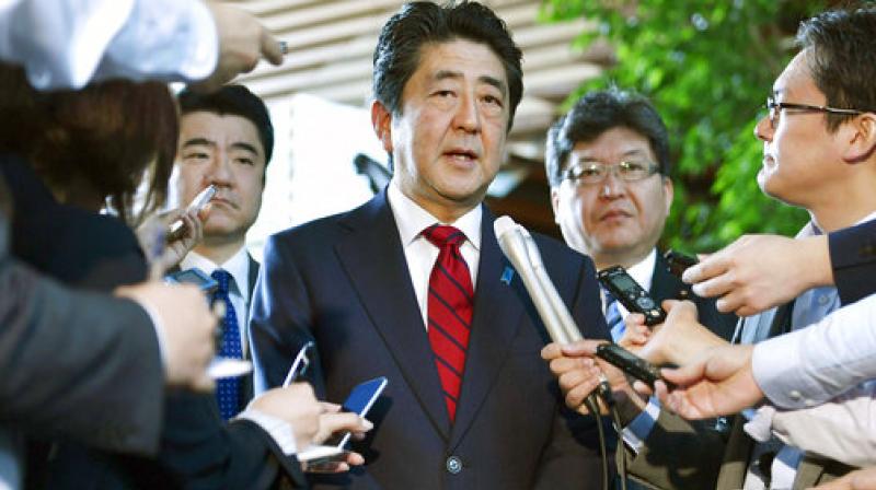 Japanese Prime Minister Shinzo Abe, center, answers to a reporters question about North Koreas missile launch, at his official residence in Tokyo. (Photo: AP)