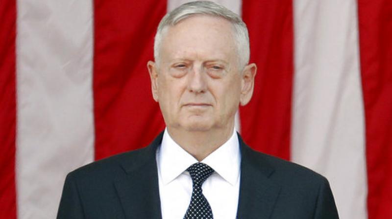 Secretary of Defense James Mattis stands in attention at the Memorial Amphitheater in Arlington National Cemetery in Arlington, Va. during a Memorial Day ceremony. Mattis suggests the Trump administrations defense policy toward Asia will look a lot like that of its predecessors. He outlined policy goals in remarks to reporters traveling with him from Hawaii to Singapore on Friday. (Photo: AP)