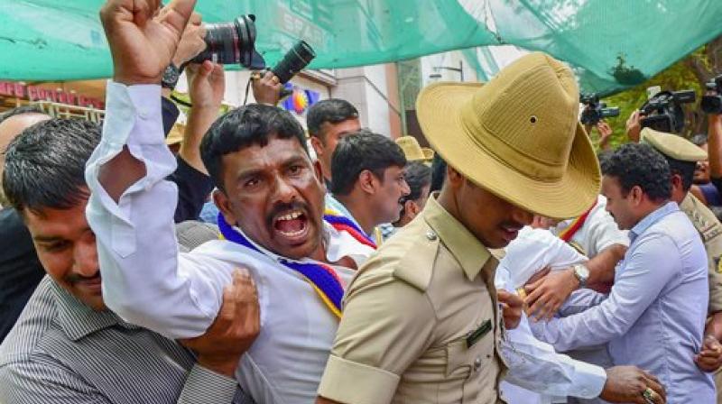 Pro-Kannada activists being detained by police personnel during their protest against Rajnikanths Kaala release, in Bengaluru on Thursday. Pro-Kannada outfits have threatened to stall release of Kaala over Rajinikanths reported remarks on the Cauvery row. (Photo: PTI)