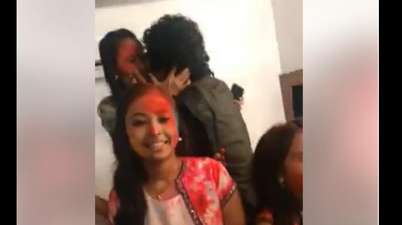 In a video that has gone viral, Papon can be seen applying colour to a contestants face and planting a kiss on her lips, leaving her stunned. (Screengrab  | Facebook @AngaraagPAPONMahanta)
