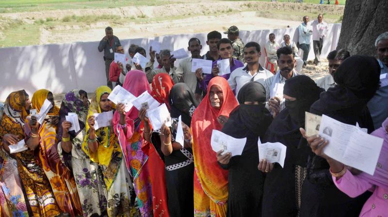Voters stand in queues to cast their votes at a polling station in UP. (Photo: PTI/File)