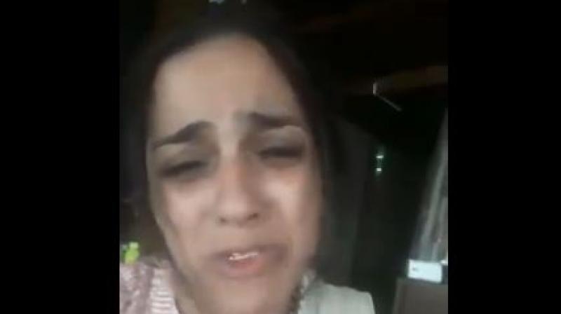In the video posted on Twitter by filmmaker Ashoke Pandit, the woman, a Khar resident, is seen weeping for help and justice.  (Photo: Screengrab | Twitter | @ashokepandit
