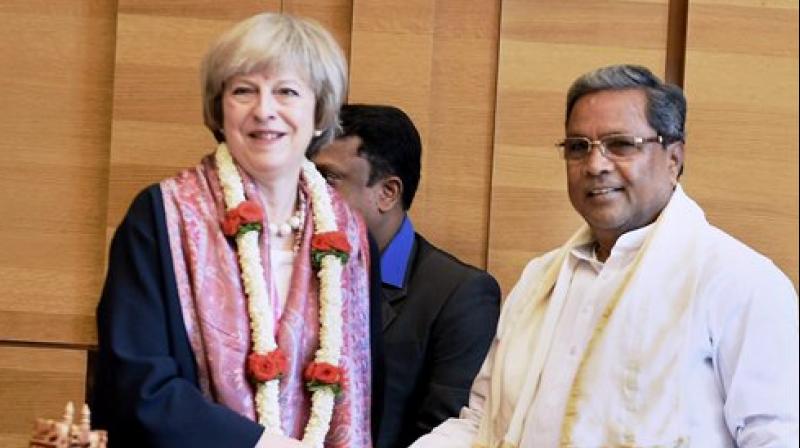 Karnataka Chief Minister Siddaramaiah welcomes U K Prime Minister Theresa May at a programme in Bengaluru on Tuesday (Photo: AP)