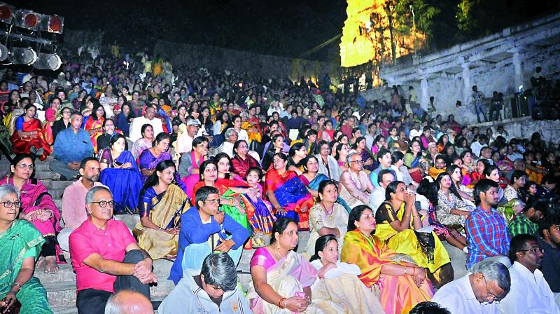 Close to 500 people in the audience enjoy the show in the temple.