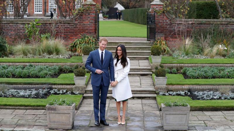 In this file photo taken on November 27, 2017 Britains Prince Harry and his fiancÃ©e US actress Meghan Markle pose for a photograph in the Sunken Garden at Kensington Palace in west London on November 27, 2017. (Photo: AFP)