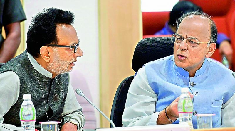 Union minister for finance Arun Jaitley and revenue secretary Hasmukh Adhia during the16th GST Council meeting in New Delhi on Sunday (Photo: AP)