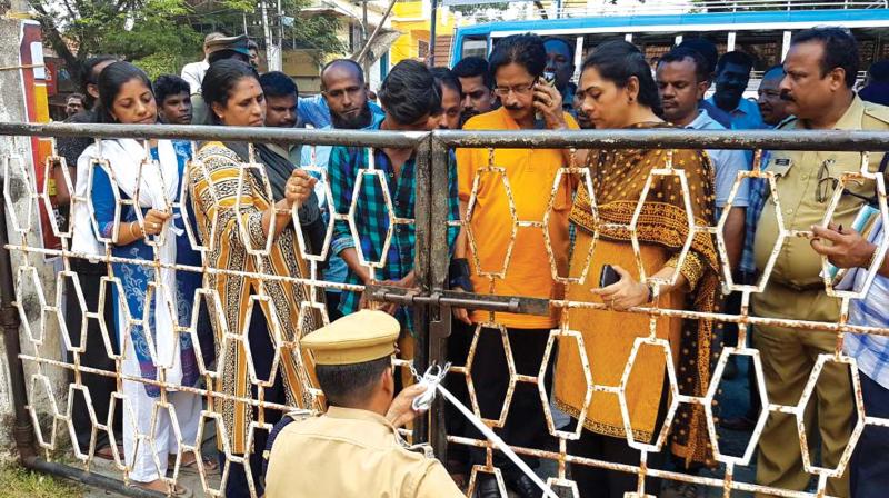 Mayor Soumini Jain and other officials seal the Kokkers theatre with police  support in Kochi on Wednesday. (Photo: DC)