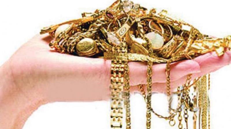 Gold prices up marginally; silver tumbles by Rs 590 per kg