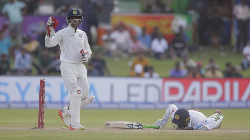 Wriddhiman Saha pulled off two stunning catches, one to dismiss Kusal Mendis and the other to get rid of Angelo Mathews in the 2nd Test. (Photo: AP)