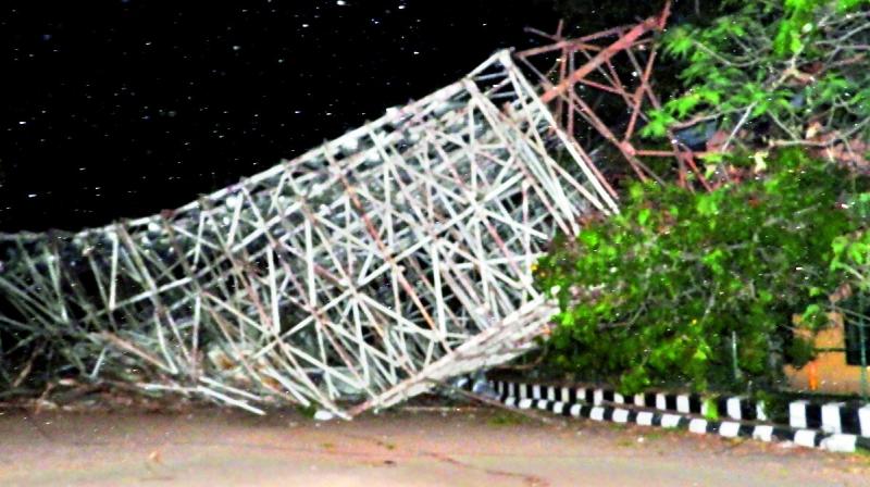 Wreckage of the gigantic floodlight tower of the Lal Bahadur Stadium that was felled by a gale lies in the premises on Monday. 	(Image: P. Anil Kumar)