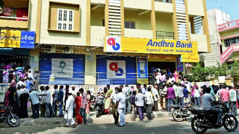 People queue up to collect cash and to deposit demonetised currency notes in front of banks in the city on Thursday.  (Photo: S. Surender Reddy)