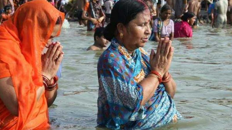 Devotees praying while taking bathing in the river Ganga. (Photo: Twitter | ANI)