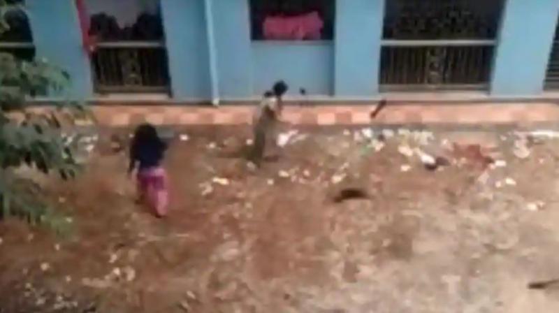 A video grab shows two women clobbering 16 puppies to death in Kolkata. (Photo: Sourced from Facebook)