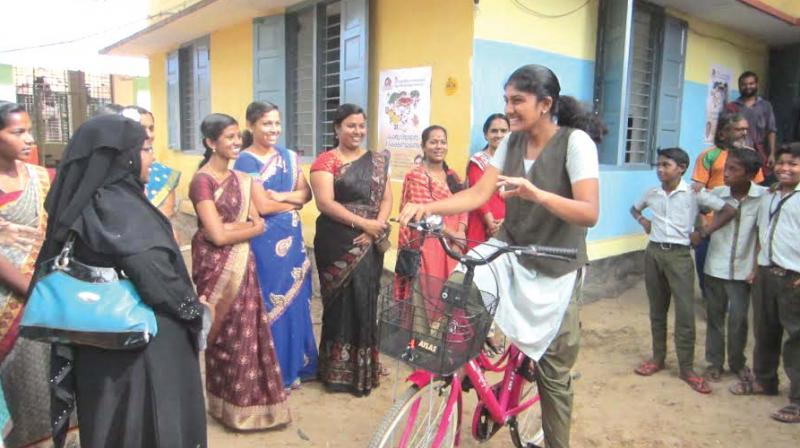 R Varsha, student of Government Central High School, Attakkulangara, with the cycle she received as part of ICE Donate a Cycle campaign on Friday.	(Photo: DC)