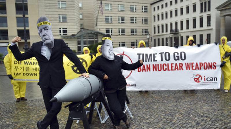 In this Sept. 13, 2017 file photo activists of the International Campaign to Abolish Nuclear Weapons (ICAN) protest against the conflict between North Korea and the USA with masks of the North Korean ruler Kim Jong Un, right, and the US president Donald Trump, left, in front of the US embassy in Berlin, Germany.  (Photo: AP)