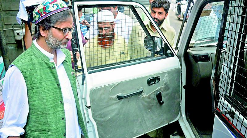 Jammu and Kashmir police detain JKLF chairman Mohammad Yasin Malik while he was going for a joint separatist meeting in Srinagar on Monday. (Photo: PTI)