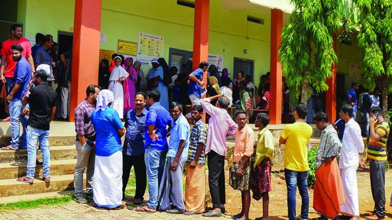 People wait in long queues to cast their votes at a polling station during the third phase of Lok Sabha polls at Batheri in Wayanad on Tuesday. (Photo: AP)