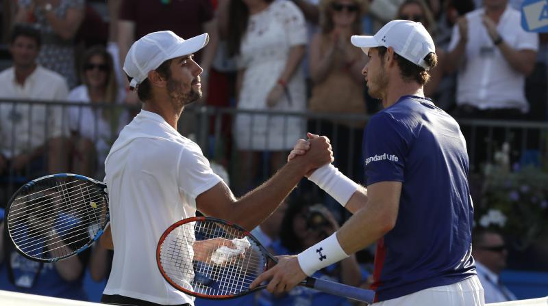 Jordan Thompson of Australia, left, shakes hands with Andy Murray of Britain after winning match on day two of the Queens Club tennis tournament in London. (Photo:AP)
