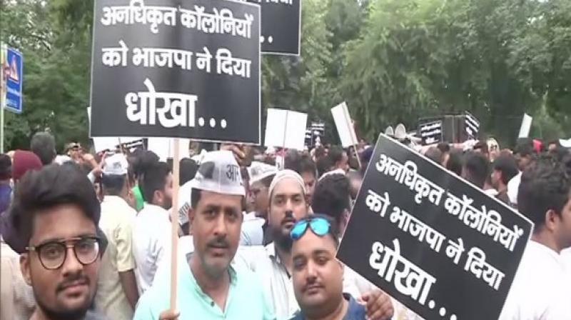 AAP party workers protest outside BJP headquarters in Delhi