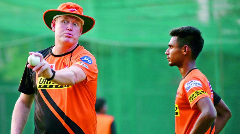 Sunrisers coach Tom Moody (left) gives bowling tips to Mustafizur Rahman at practice on Tuesday.(Photo: S. Surender Reddy)