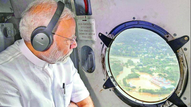 Prime Minister Narendra Modi conducts an aerial survey of flood-affected areas in Kerala on Saturday. (Photo: PTI)