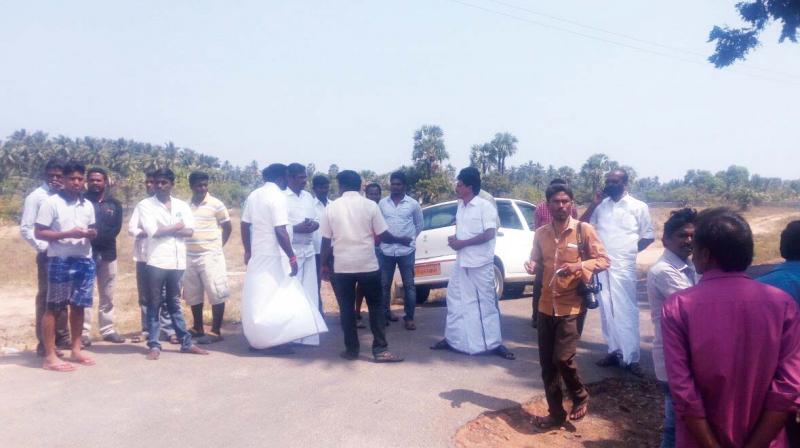 AIADMK men checking people on the road leading to Golden Bay resort in Kuvathur on Saturday. (Photo: DC)