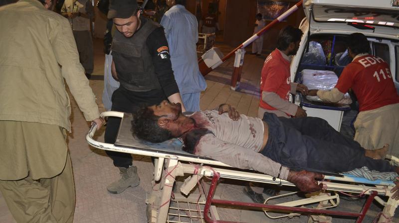 Pakistani volunteers rush an injured person to a hospital in Quetta, Pakistan. (Photo: AP)