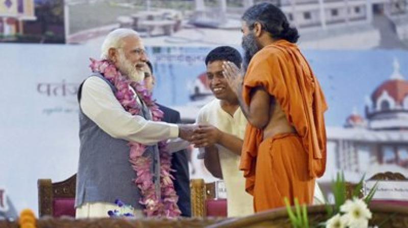 Narendra Modi being welcomed by Swami Ramdev and Balkrishan at the inauguration of the Patanjali Research Institute in Haridwar, Uttarakhand on Wednesday. (Photo: PTI)