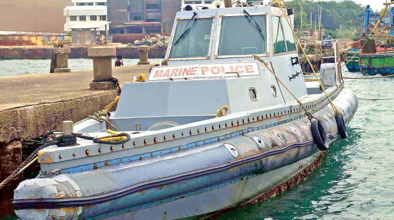 A marine police patrol boat awaiting maintenance repairs. Inset: ADGP Vanniya Perumal reviews coastal security at Ramanathapuram. (Image DC)