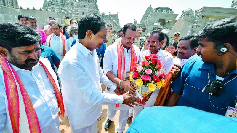 Chief Minister K. Chandrasekhar Rao receives a bouquet from Congress Bhongir MP Komatireddy Venkata Reddy, who was present in the temple during the CMs visit, at Yadadri on Saturday. Being a critic of the TRS government, Mr Reddys meeting the Chief Minister came as a surprise. (Photo: DC)
