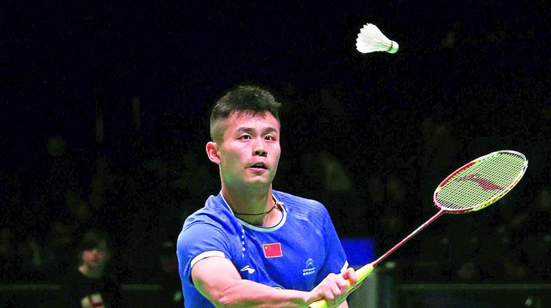 Qiao Bin of China plays a shot during his mens singles first round match against H. S. Prannoy of India at the All England Open Badminton Championships in Birmingham on Wednesday (Photo: AP)